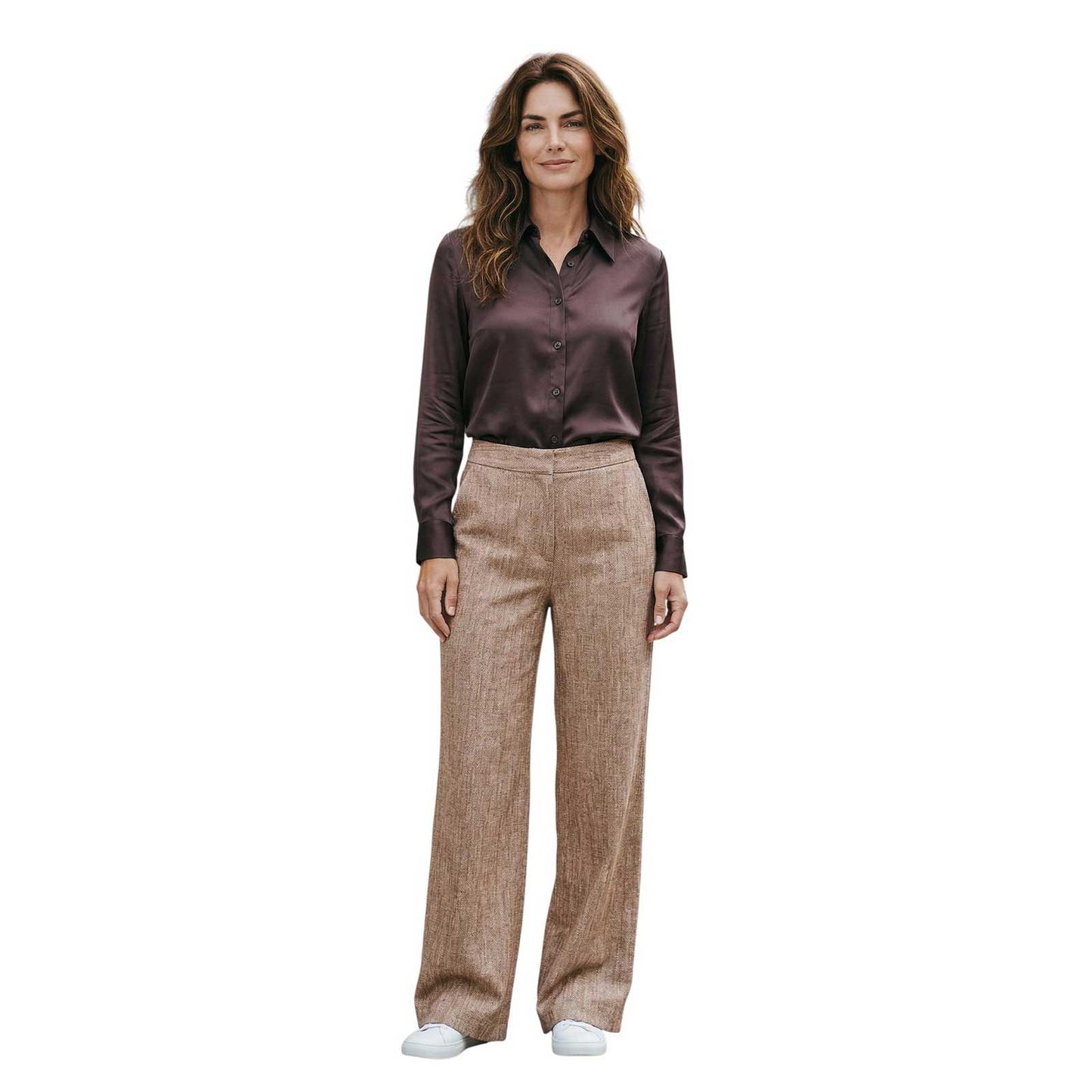Woman wearing a brown satin shirt and beige pants sand sold at Aqualta