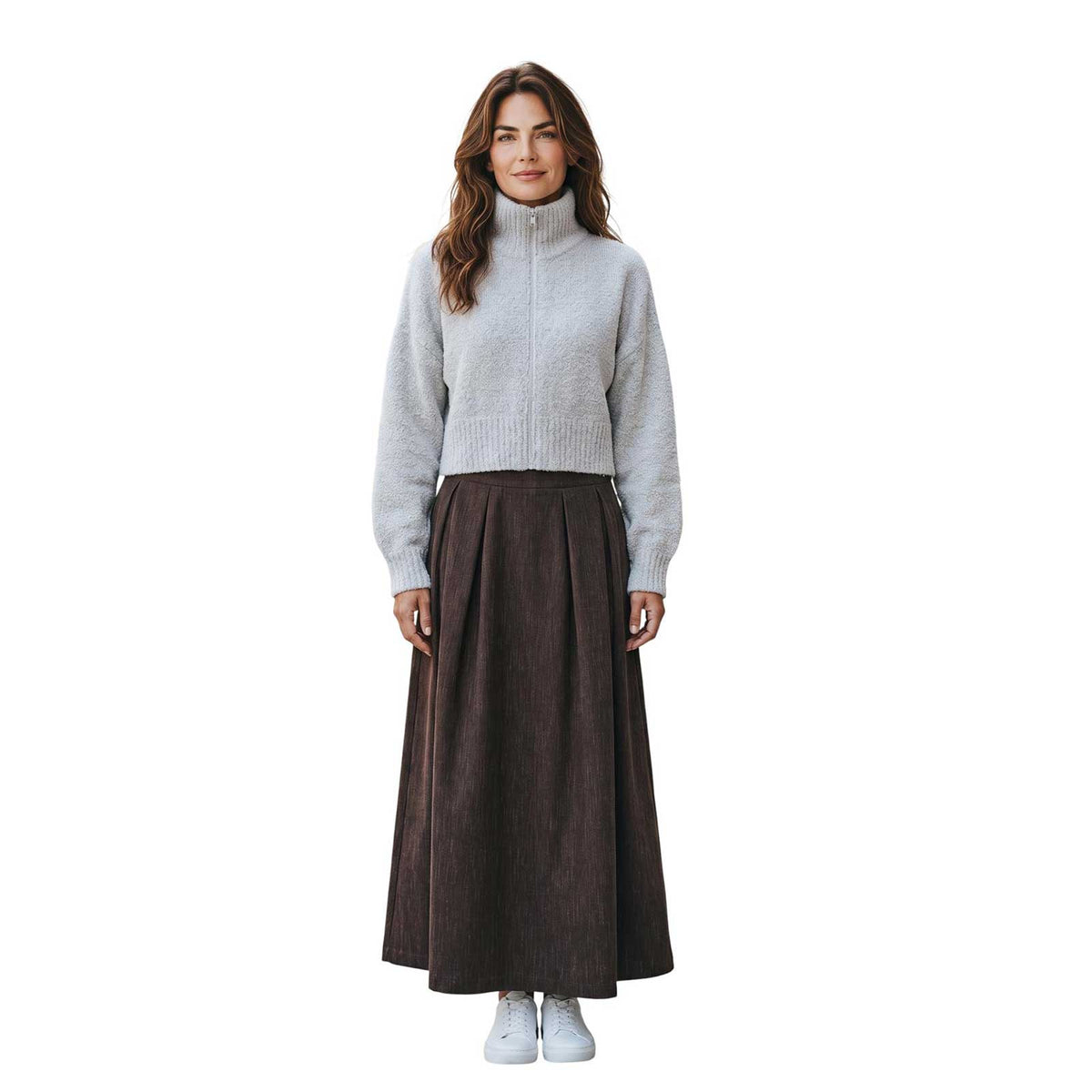 Woman wearing a high neck zipped mohair sweater in oatmeal by Sand, sold at Aqualta, styled with a long dark skirt and white sneakers.