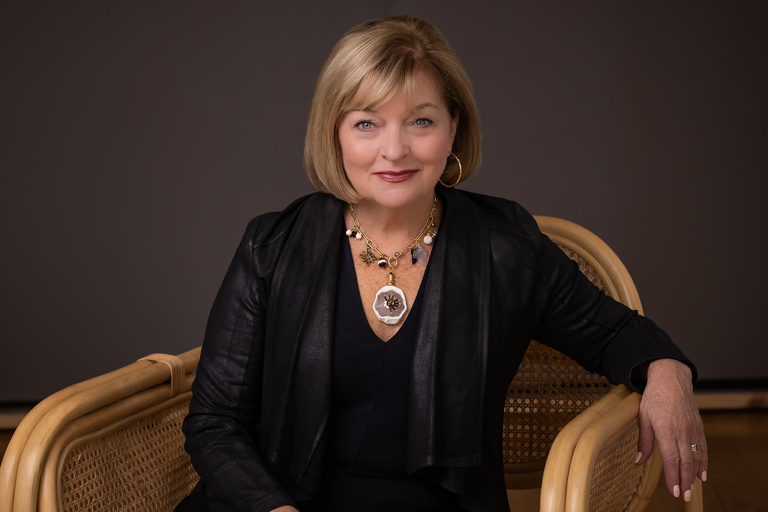 Peggy Goodman, jewelry designer at Aqualta Wear, showcasing her statement necklace and luxury accessories