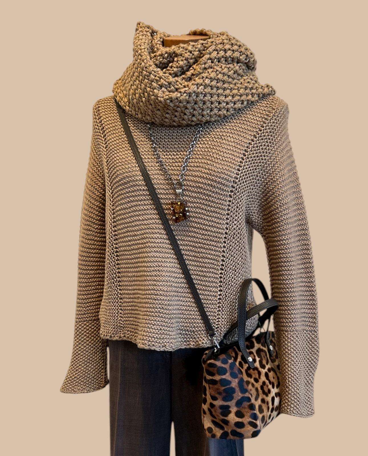 Knitted sweater with leopard knitted scarf and bag on a beige background