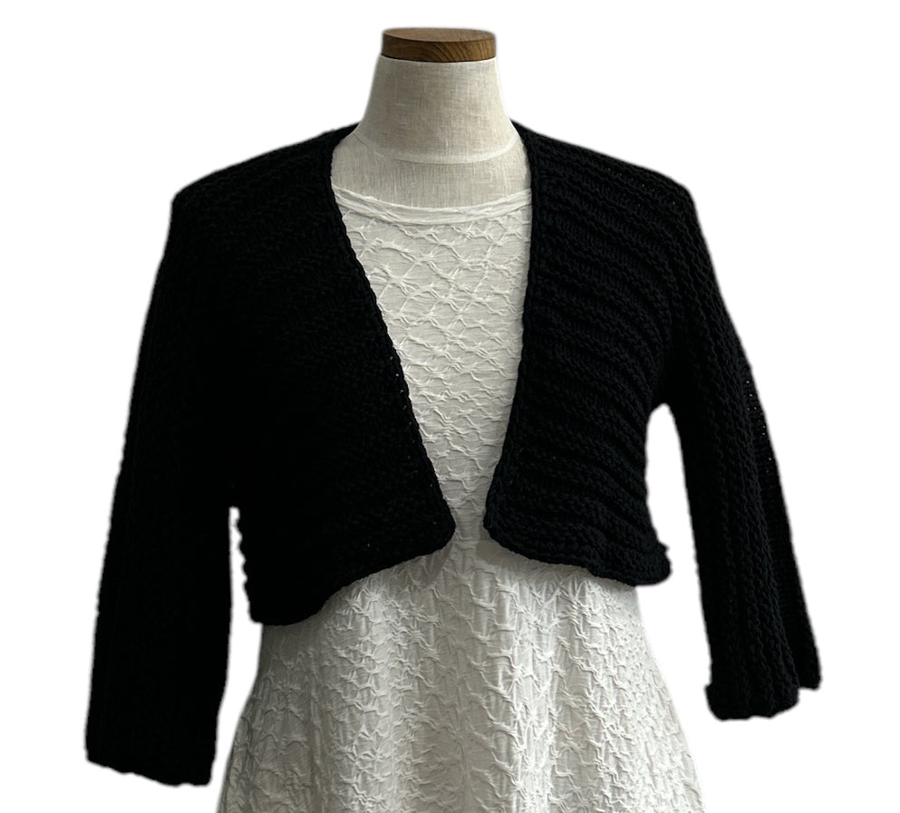 Elegant black knit shrug by Chiara Toffanin, handmade in Italy and sold at Aqualta