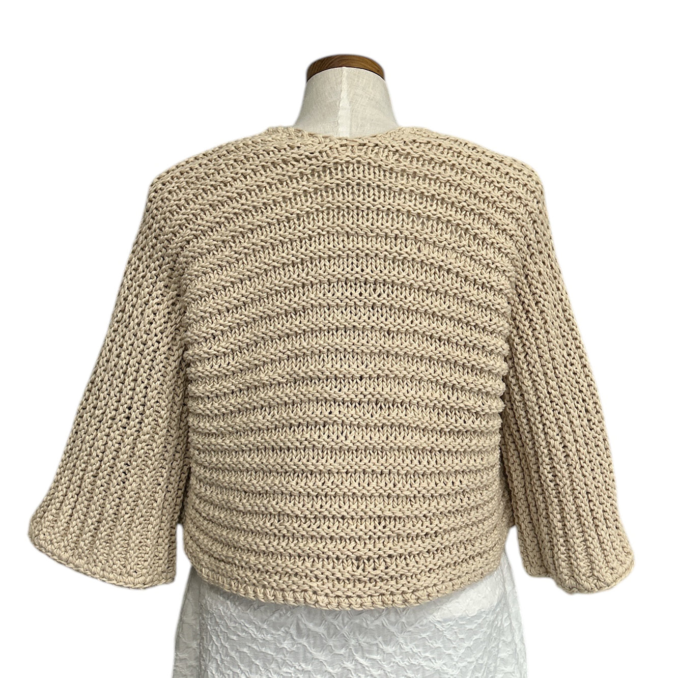 Italian-made beige cropped knit shrug by Chiara Toffanin at Aqualta