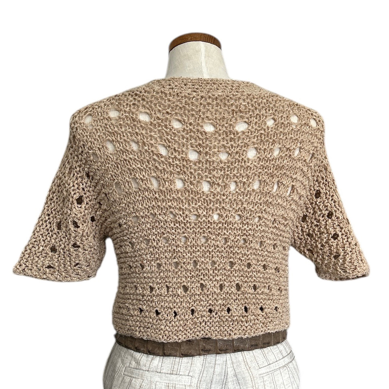 Back view of the almond short-sleeve knit top by Chiara Toffanin with airy mesh texture
