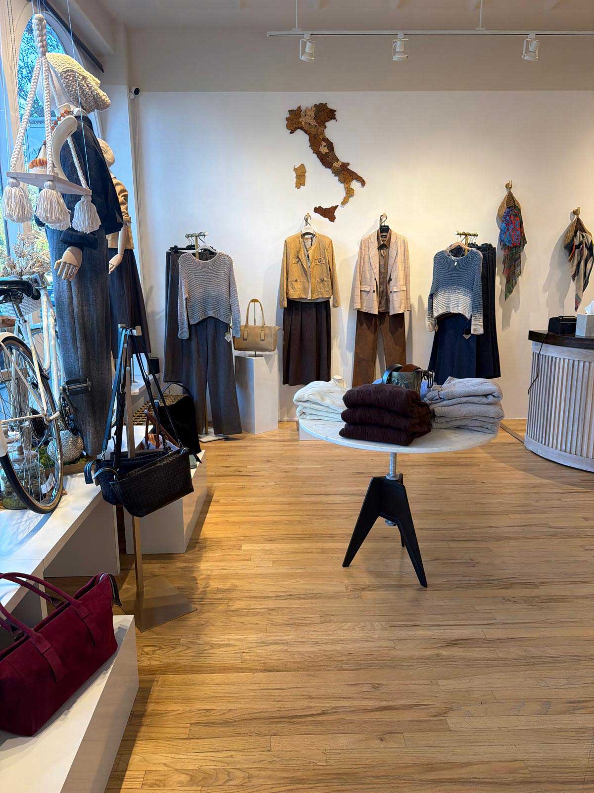 Bright interior of Aqualta store with hardwood floors, modern lighting and fashion displays.