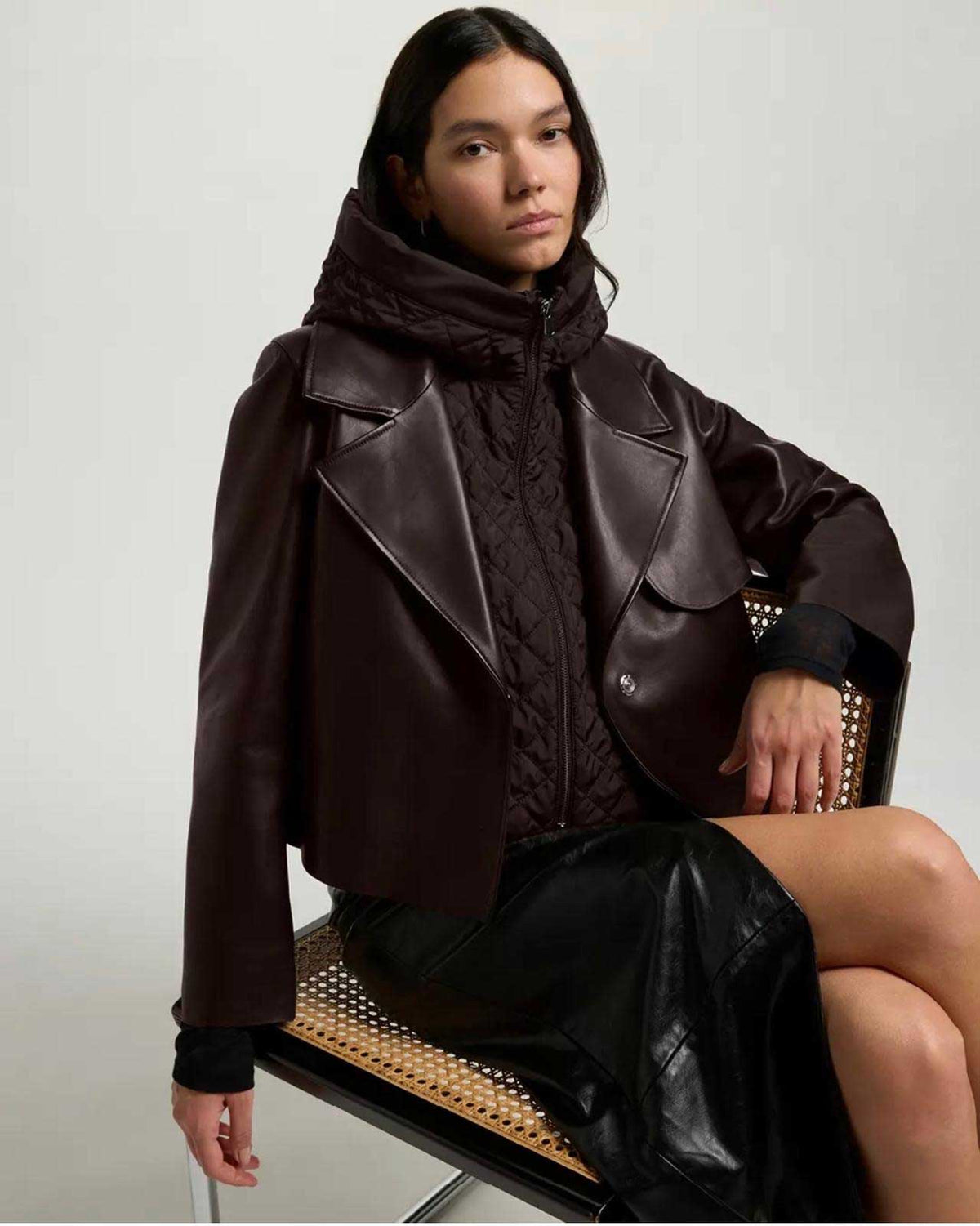 Suprema women’s brown leather aviator jacket with layered quilted black hooded vest.