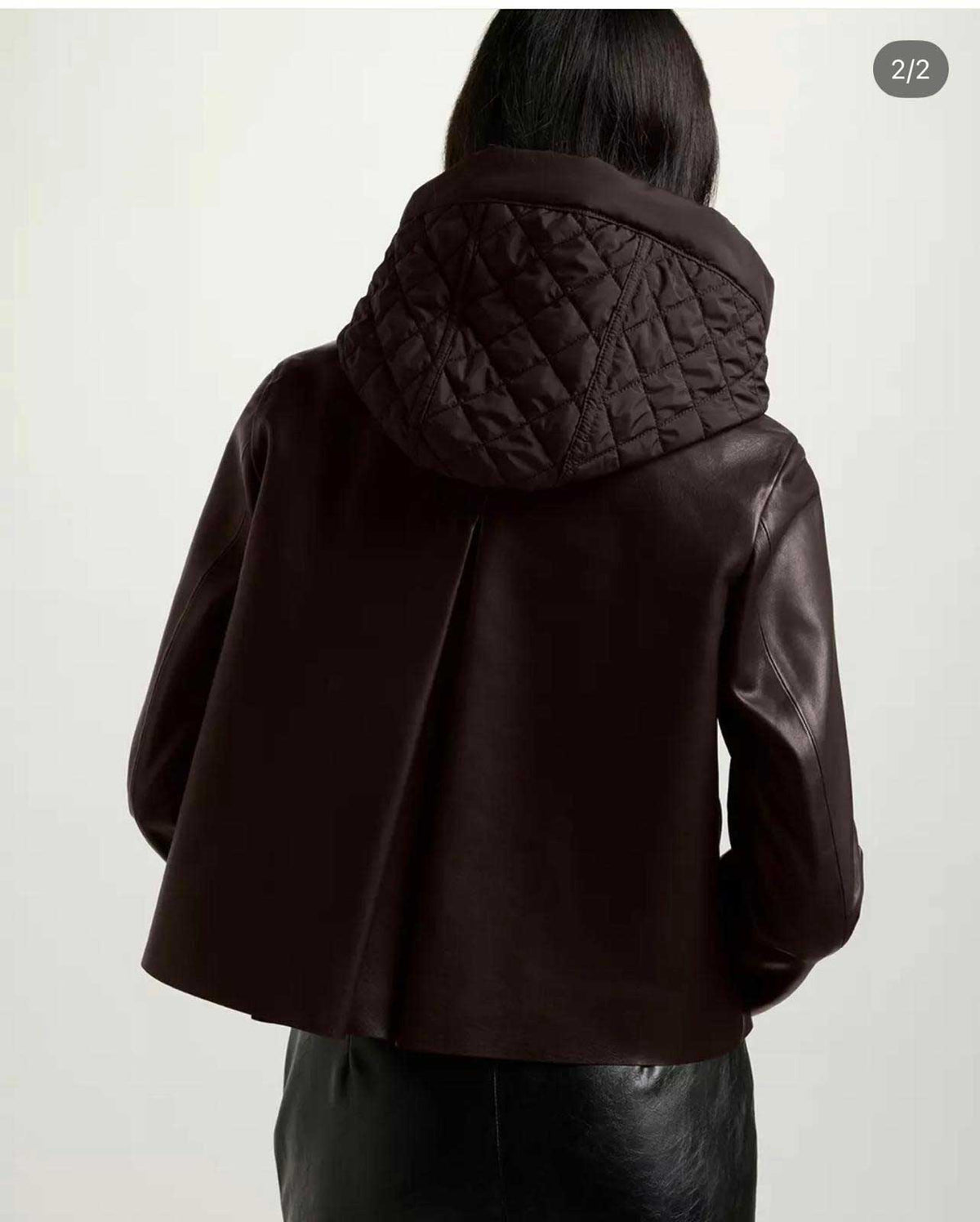 Women’s brown leather jacket by Suprema featuring wide lapels and a removable hooded insert.