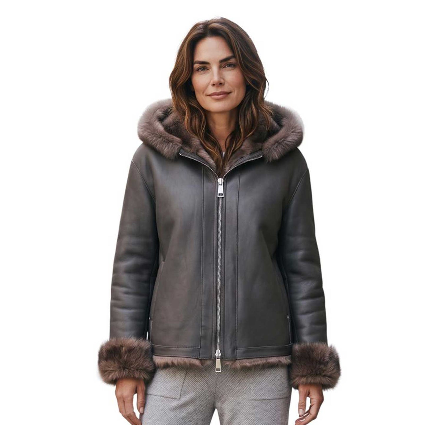 A woman wearing a dark brown leather aviator-style jacket with a brown fur-trimmed hood and matching fur-trimmed cuffs, paired with gray pants