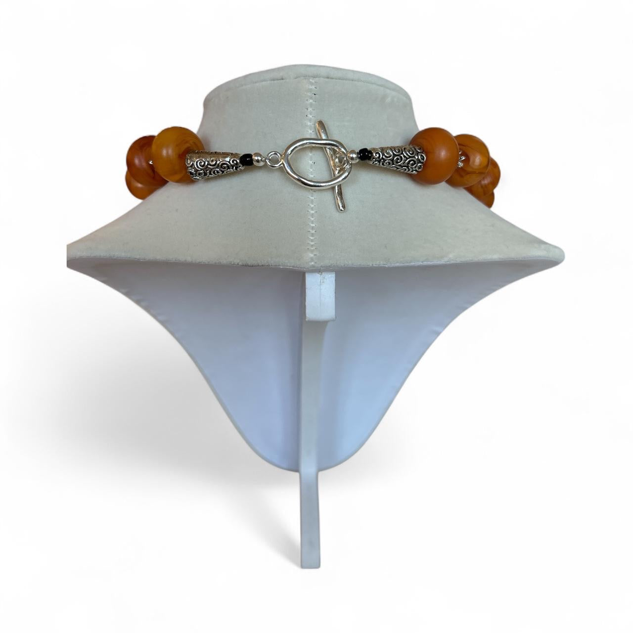 Exclusive Peggy Goodman necklace featuring genuine amber beads and bold black agate stone centerpiece, handmade jewelry at Aqualta 2