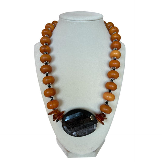 Exclusive Peggy Goodman necklace featuring genuine amber beads and bold black agate stone centerpiece, handmade jewelry at Aqualta