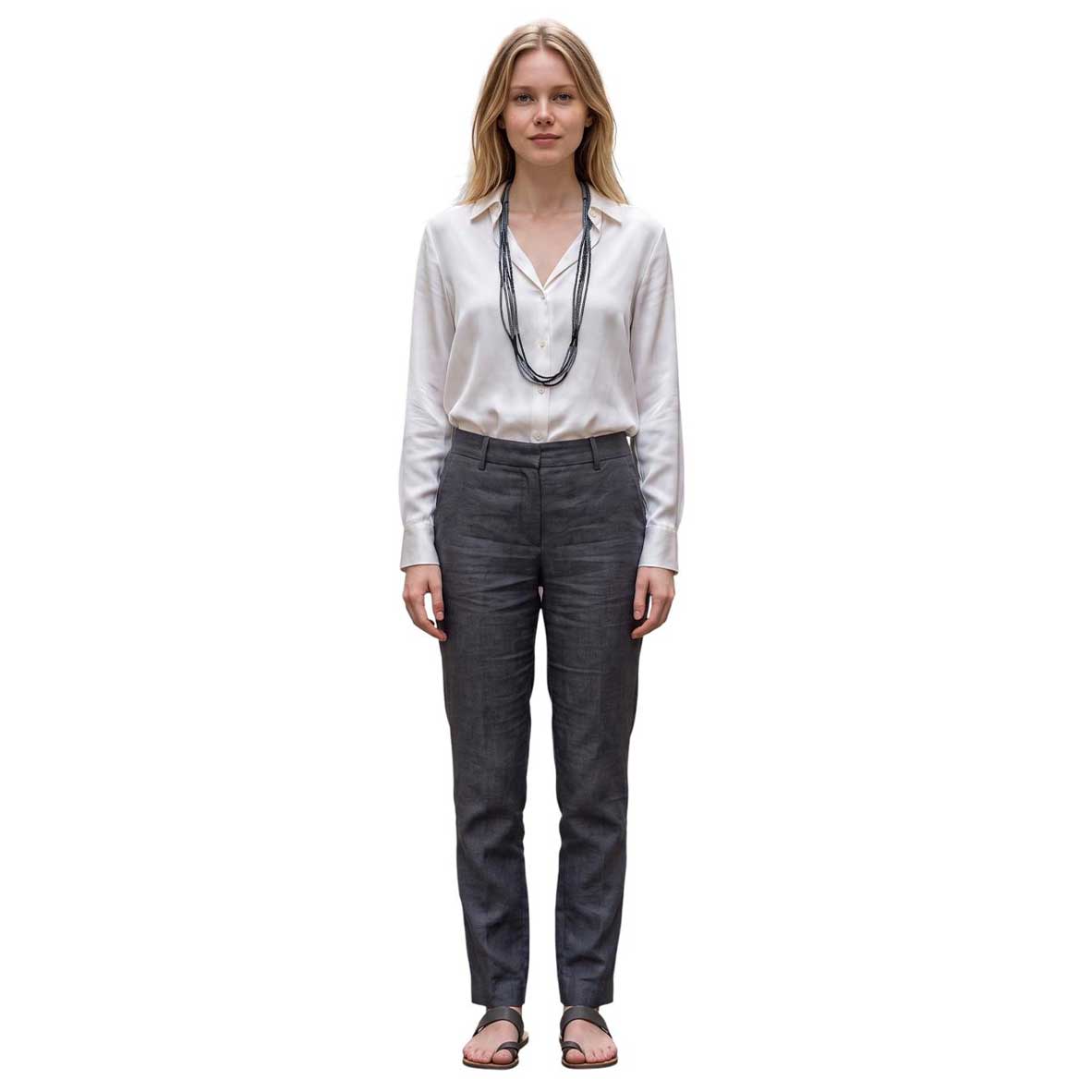 Model wearing a Peggy Goodman long multi-strand beaded necklace over a white blouse, styled with gray trousers, at Aqualta.