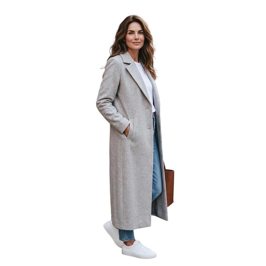 Woman wearing a long oatmeal cashmere blend coat by Sand, sold at Aqualta, with jeans and white sneakers.