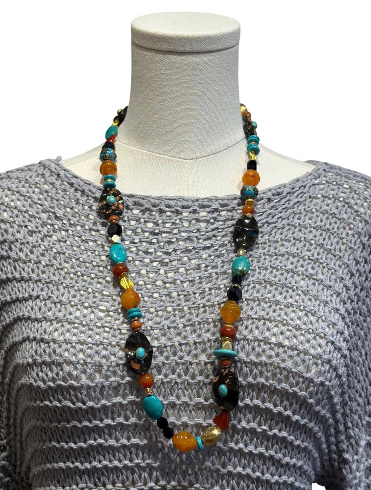 Peggy Goodman long necklace featuring turquoise, amber, black and multicolored stones, sold at Aqualta.