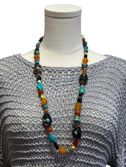 Peggy Goodman long necklace featuring turquoise, amber, black and multicolored stones, sold at Aqualta.