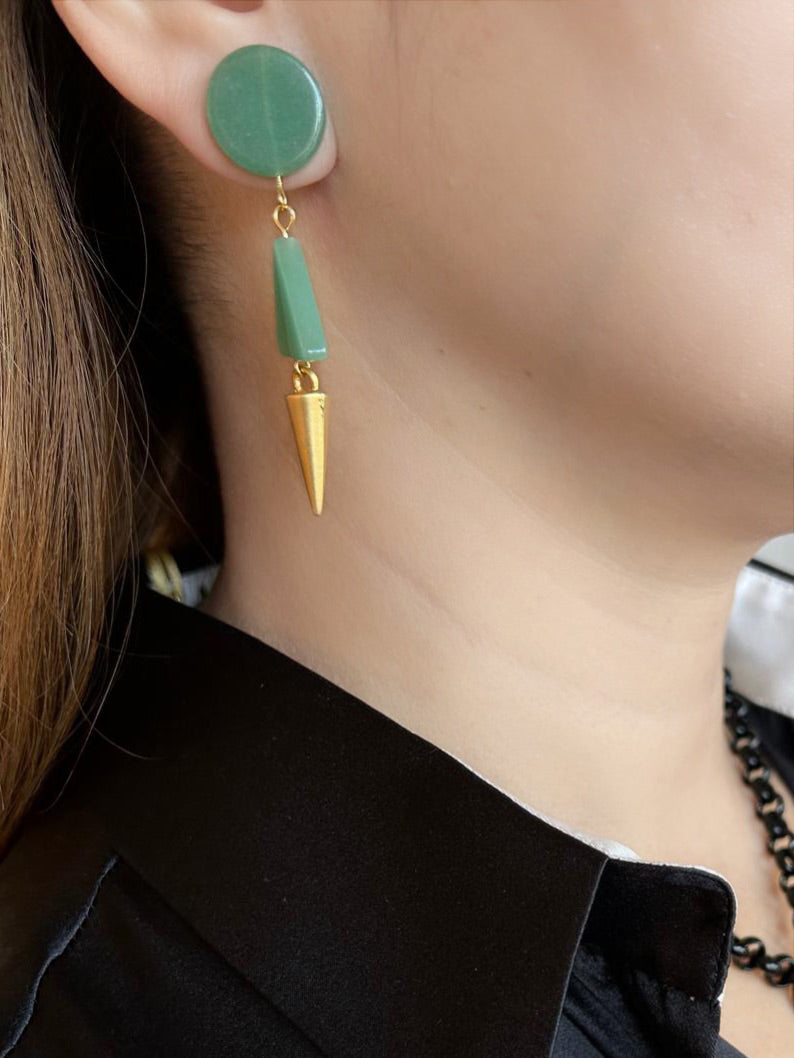 Women wearing Handmade earrings by Peggy Goodman for Aqualta, featuring geometric green stones with gold cone dangle accents