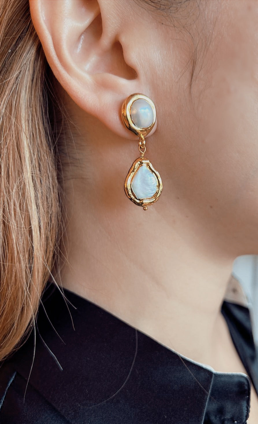 Women wearing Exclusive Peggy Goodman pearl stud earrings with gold detailing, elegant handmade jewelry at Aqualta