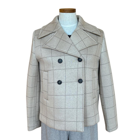 Plaid patterned coat on a mannequin against a white background Sold at Aqualta