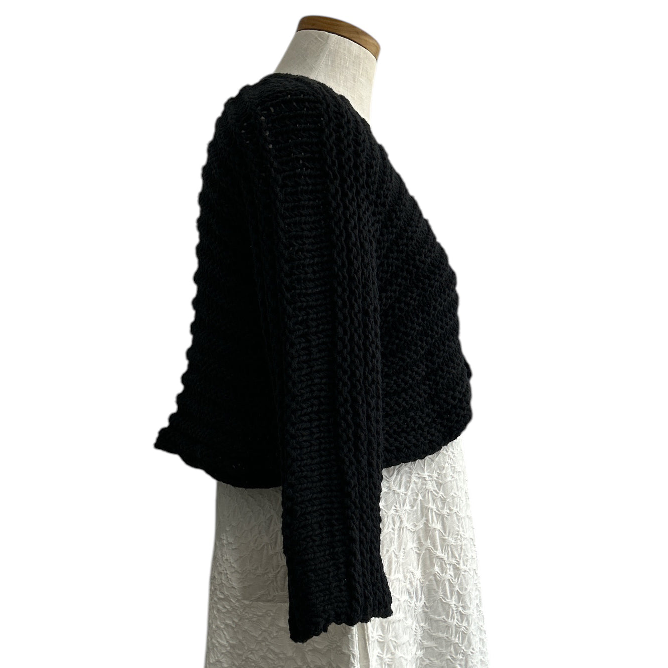 Italian-designed black open-knit shrug by Chiara Toffanin, available at Aqualta