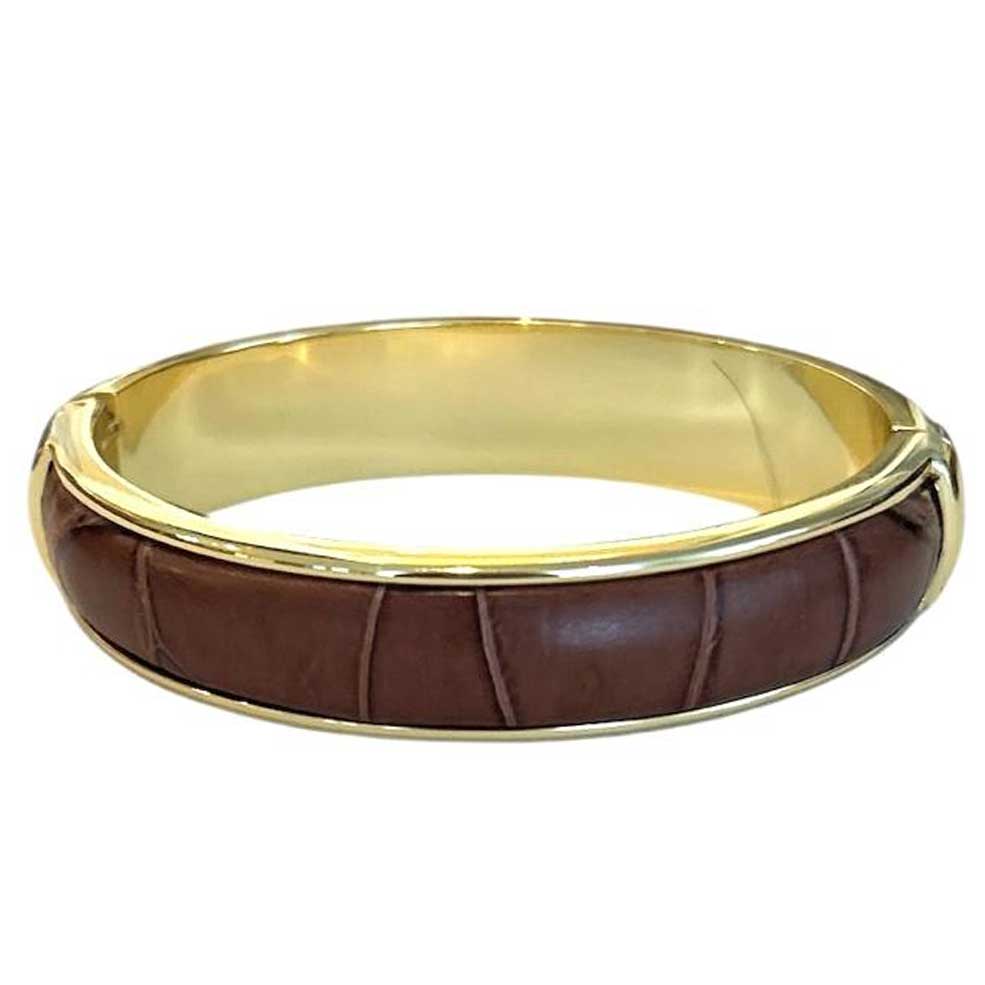 A simple classic brown leather metal bangle, made with a crocodile over brass Biagini sold at Aqualta