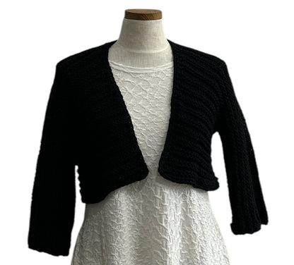 Elegant black knit shrug by Chiara Toffanin, handmade in Italy and sold at Aqualta