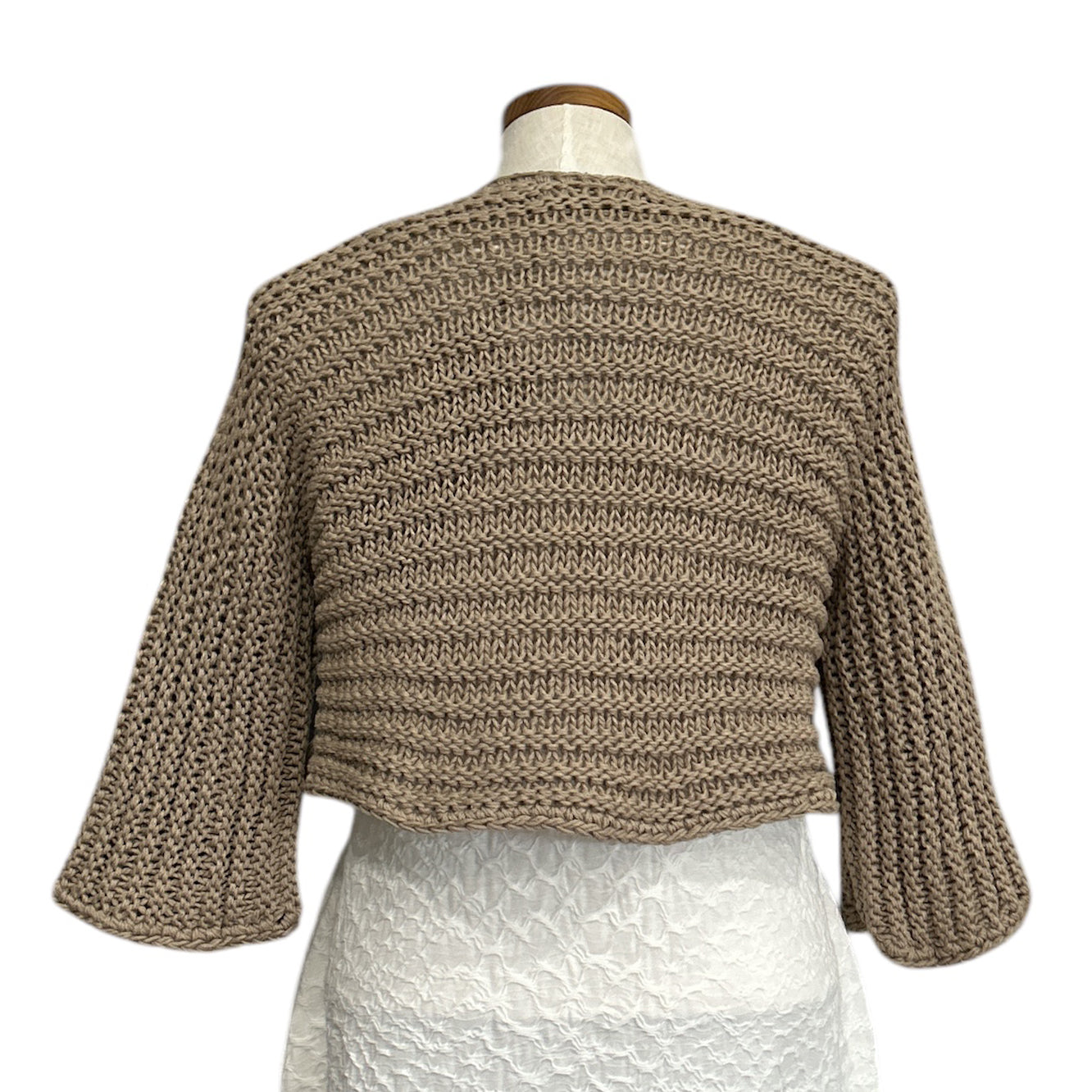 Italian-made cotton shrug in soft beige by Chiara Toffanin, available at Aqualta