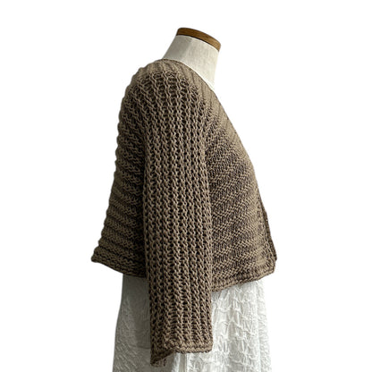 Handcrafted open-knit shrug in neutral sand tone from Chiara Toffanin collection at Aqualta